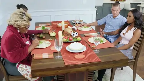 Tattooed ebony tramp is riding a BWC by the table