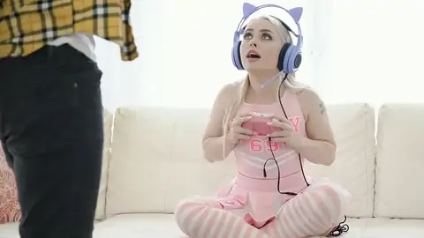 Cosplaying towheaded wearing headphones while gaming