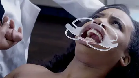 Medic bangs face of astonished patient in the medical center